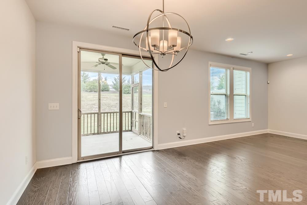 1207 Catch Fly Lane Durham, NC 27713 - Photo 12 of 28 an empty room with wooden floor and windows