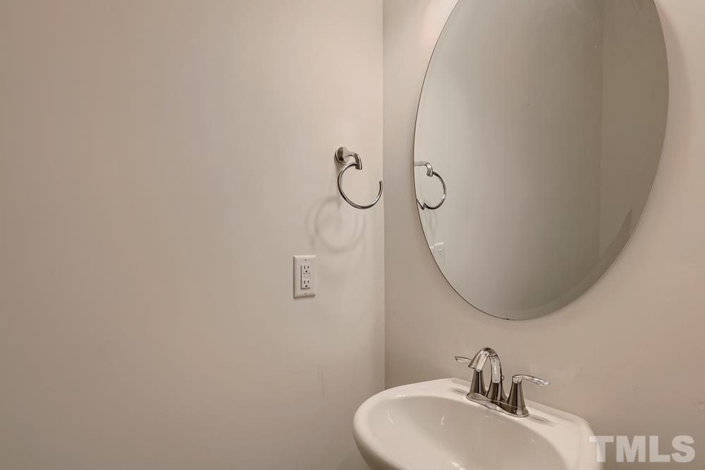 1207 Catch Fly Lane Durham, NC 27713 - Photo 13 of 28 a bathroom with a sink and mirror