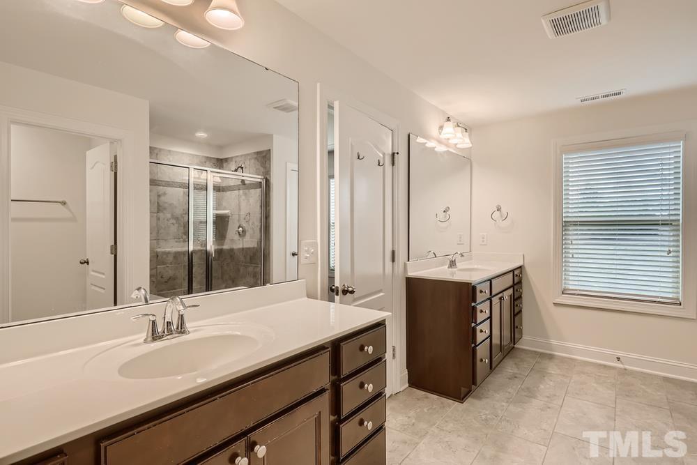 1207 Catch Fly Lane Durham, NC 27713 - Photo 16 of 28 a spacious bathroom with a double vanity sink mirror and double