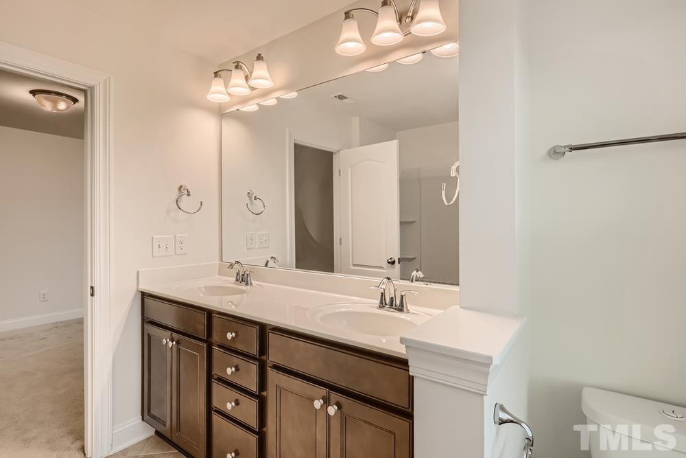 1207 Catch Fly Lane Durham, NC 27713 - Photo 23 of 28 a bathroom with a double vanity sink and a mirror