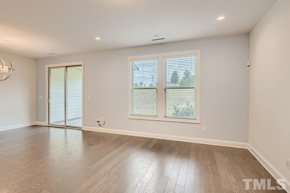 1207 Catch Fly Lane Durham, NC 27713 - Photo 5 of 28 an empty room with wooden floor and windows