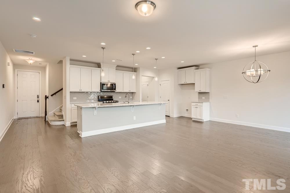 1207 Catch Fly Lane Durham, NC 27713 - Photo 6 of 28 a view of kitchen with kitchen island white cabinets and refrigerator