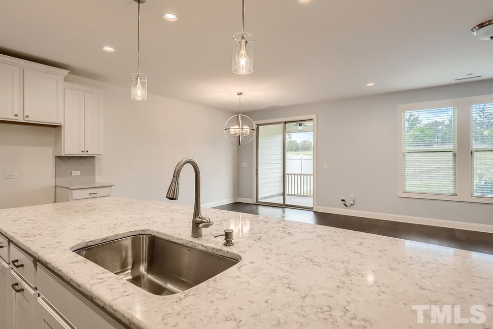 1207 Catch Fly Lane Durham, NC 27713 - Photo 9 of 28 a kitchen with a sink and a stove top oven