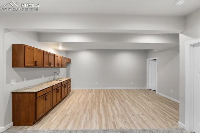 a view of a kitchen with stainless steel appliances wooden cabinets and a window