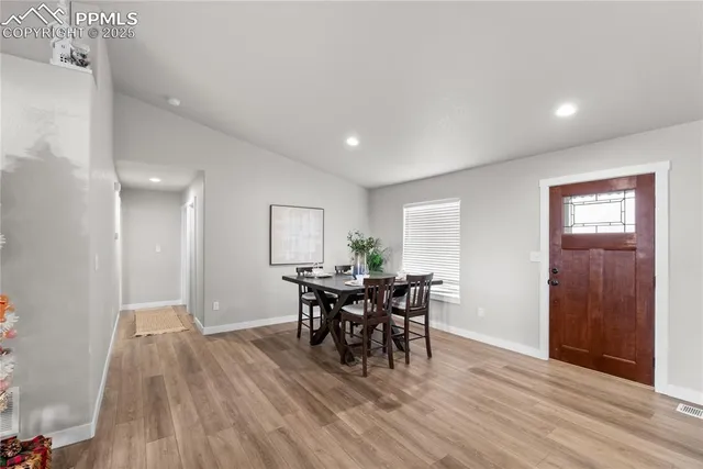 a view of a dining room with furniture and wooden floor