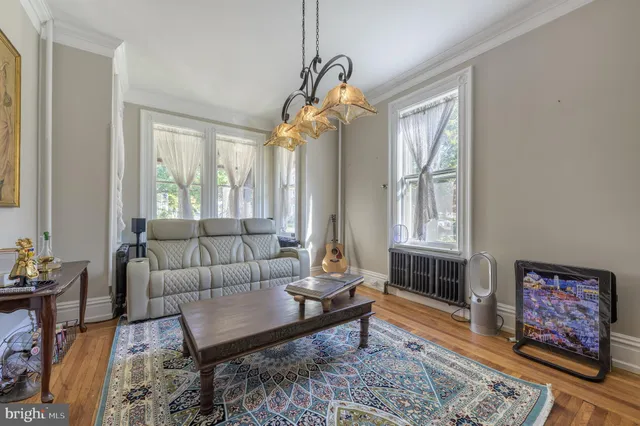 a room with furniture pool table and window
