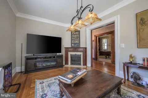 a living room with a table chairs and a window