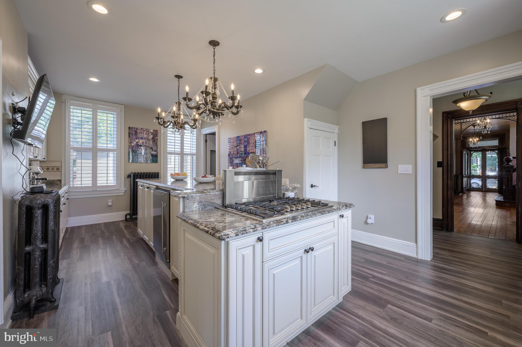 48 Broad Street Mount Holly, NJ 08060 - Photo 25 of 63 a kitchen with stainless steel appliances granite countertop a lot of counter space and wooden floor