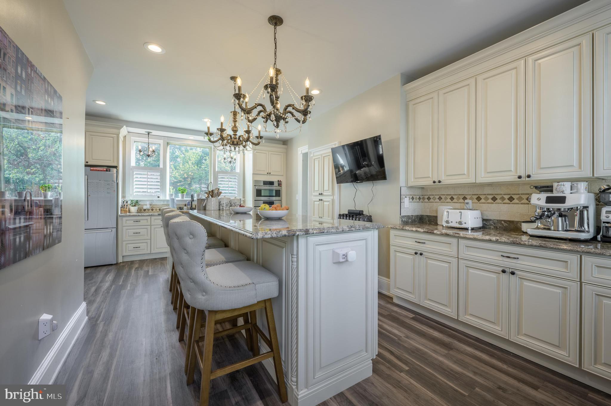 48 Broad Street Mount Holly, NJ 08060 - Photo 26 of 63 a kitchen with stainless steel appliances granite countertop a stove a sink dishwasher a dining table and chairs with wooden floor