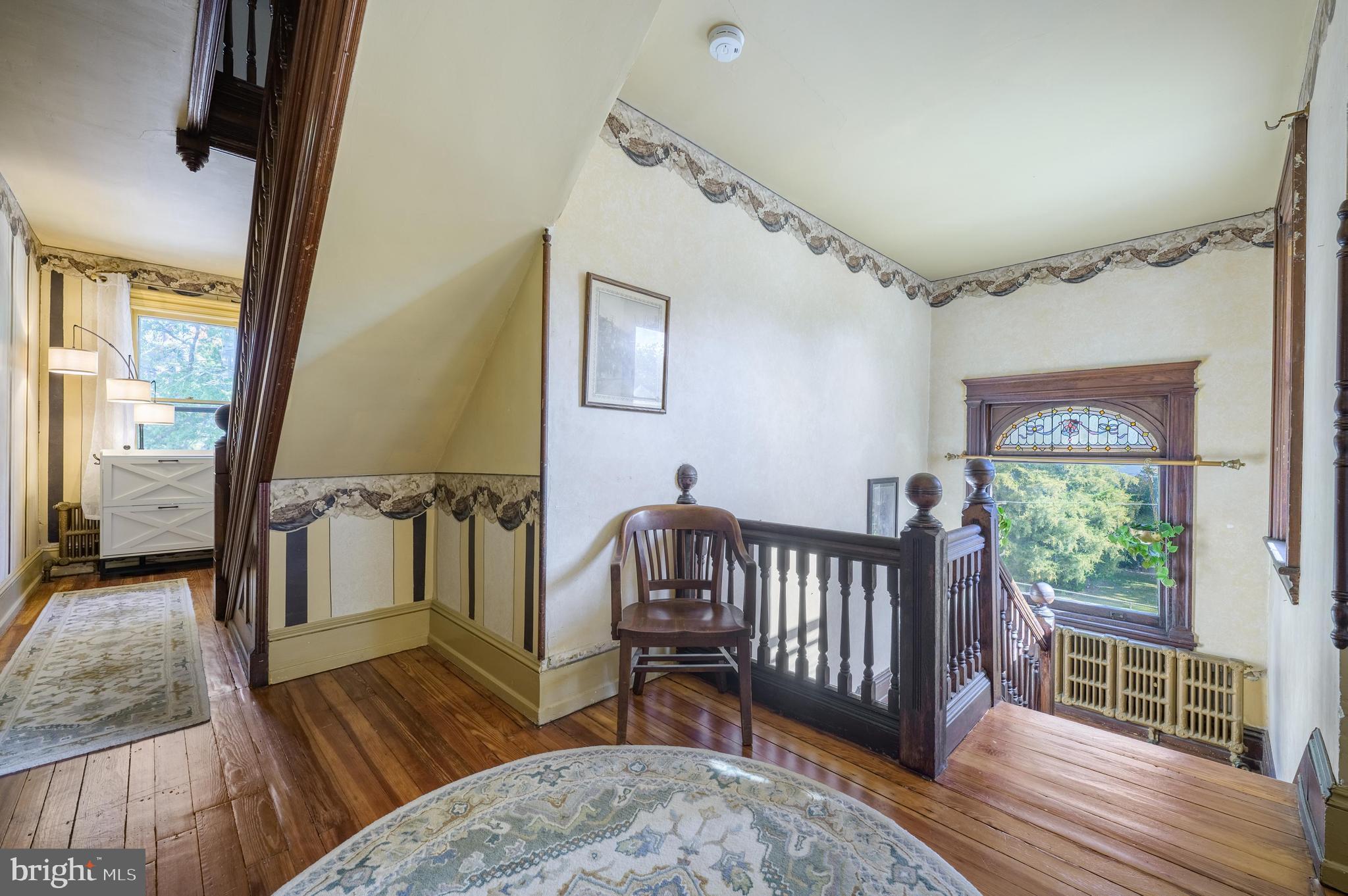 48 Broad Street Mount Holly, NJ 08060 - Photo 30 of 63 a view of a hallway with wooden floor and windows