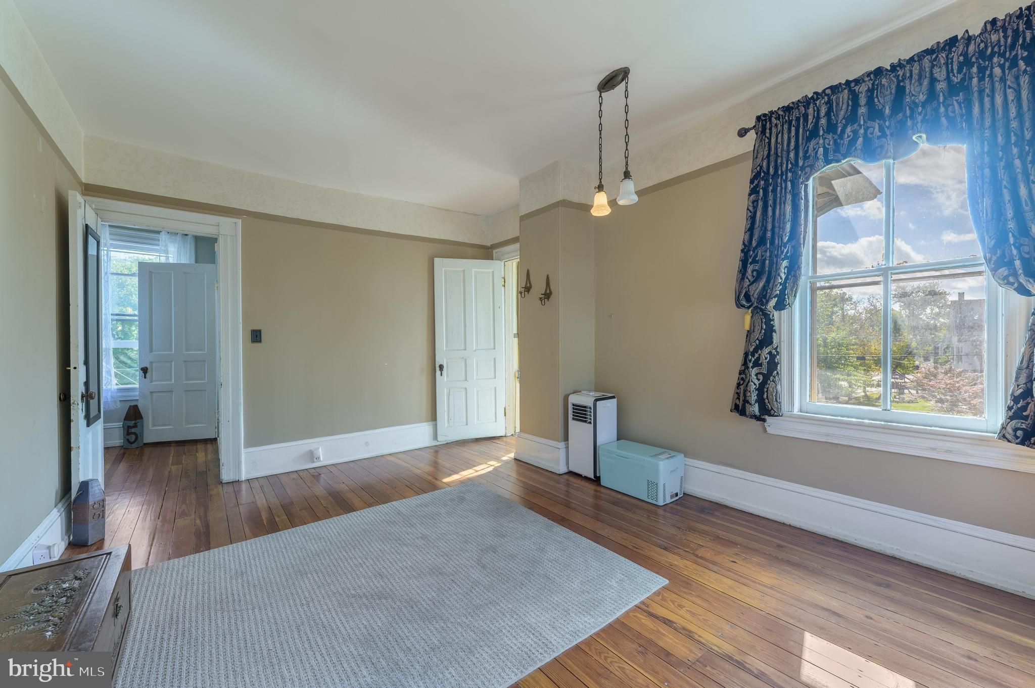 48 Broad Street Mount Holly, NJ 08060 - Photo 39 of 63 a view of an empty room with wooden floor and a window