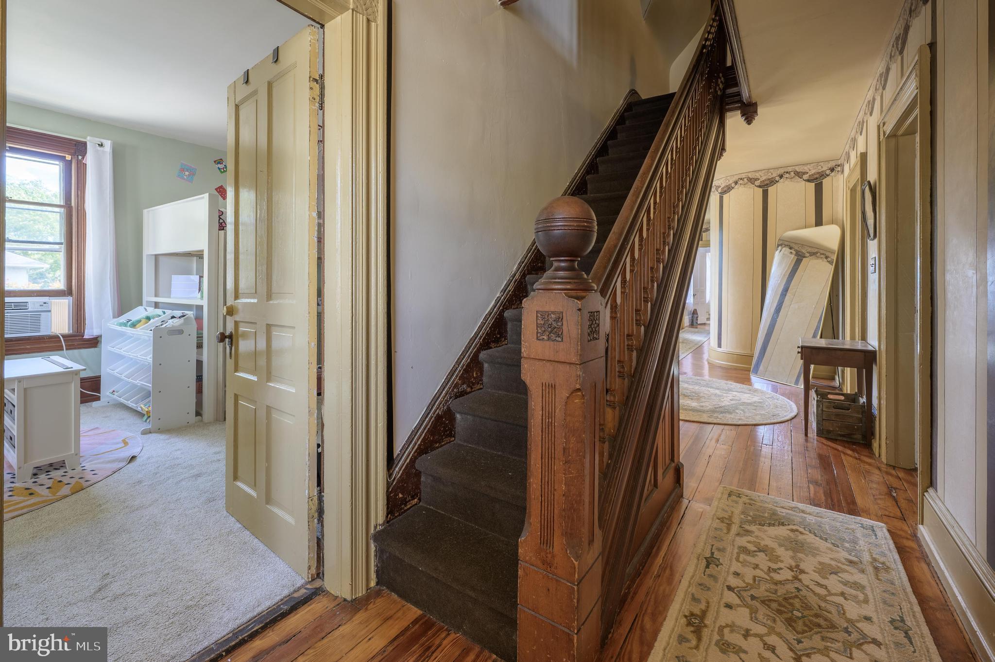 48 Broad Street Mount Holly, NJ 08060 - Photo 42 of 63 Intricately carved newel post leads to third floor