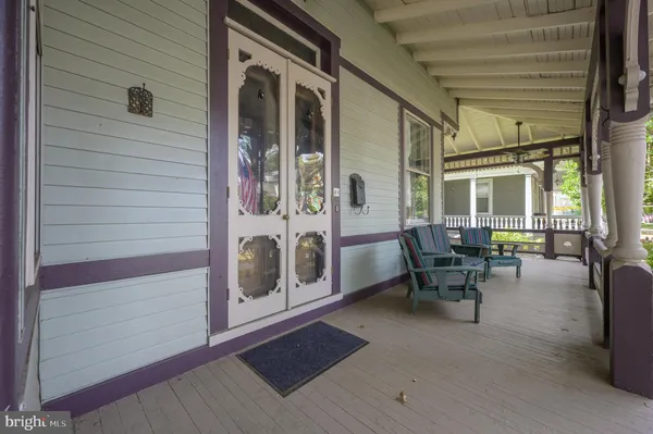 a view of an entryway with wooden floor and windows