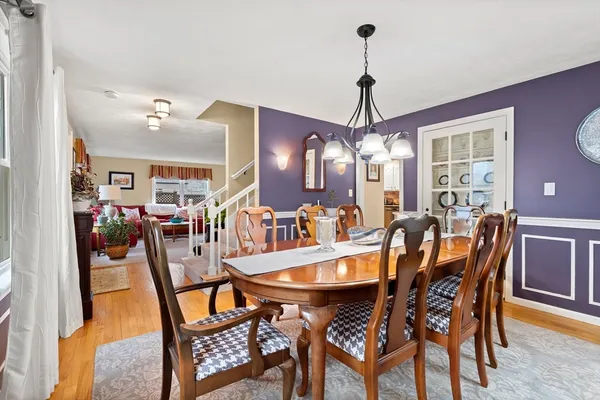 a view of a dining room with furniture and chandelier