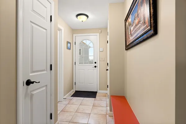 a view of a hallway with wooden floor and closet