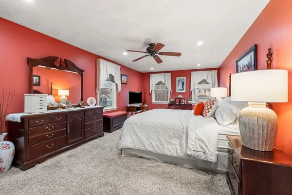 a bedroom with a bed and a dresser in it