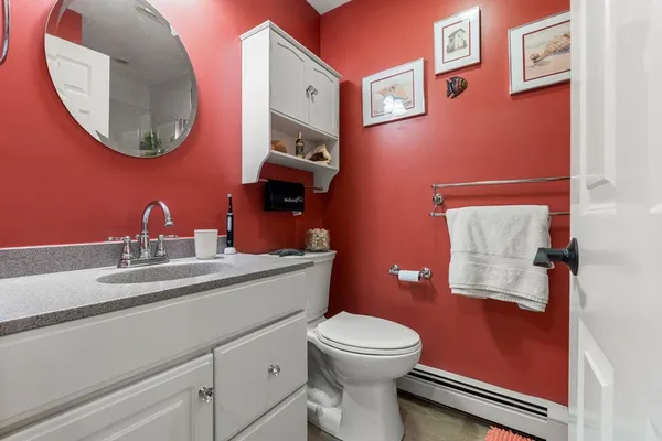 a bathroom with a toilet sink and mirror