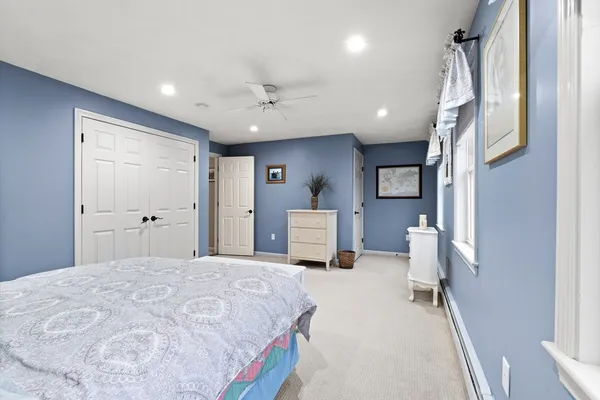 a spacious bedroom with a bed and a chandelier
