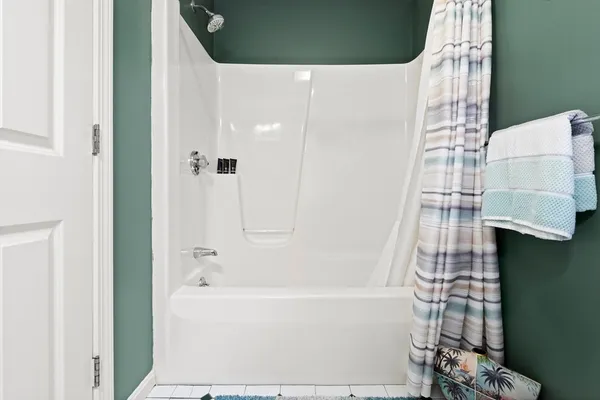a bathroom with a bathtub and shower