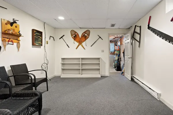 a view of a livingroom with lounge chair and windows