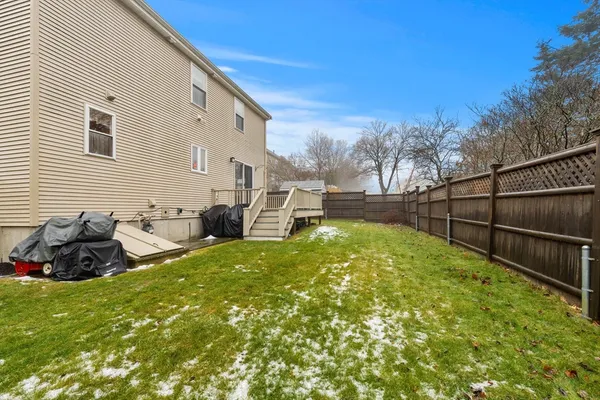 a backyard of a house with table and chairs