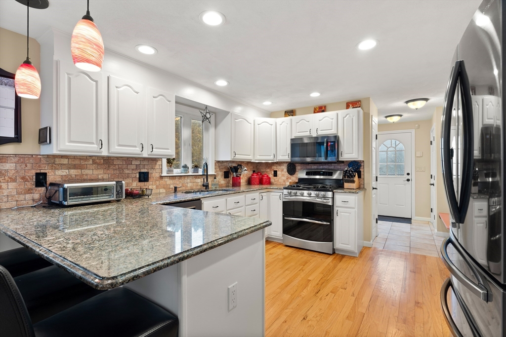 27 Folger Avenue Beverly, MA 01915 - Photo 4 of 34 a kitchen with stainless steel appliances granite countertop a stove refrigerator and a sink