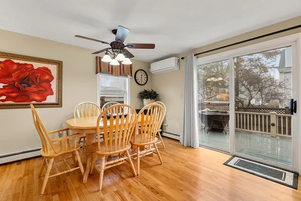 a dining room with furniture a chandelier and wooden floor