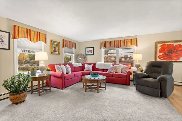 a living room with furniture and a potted plant