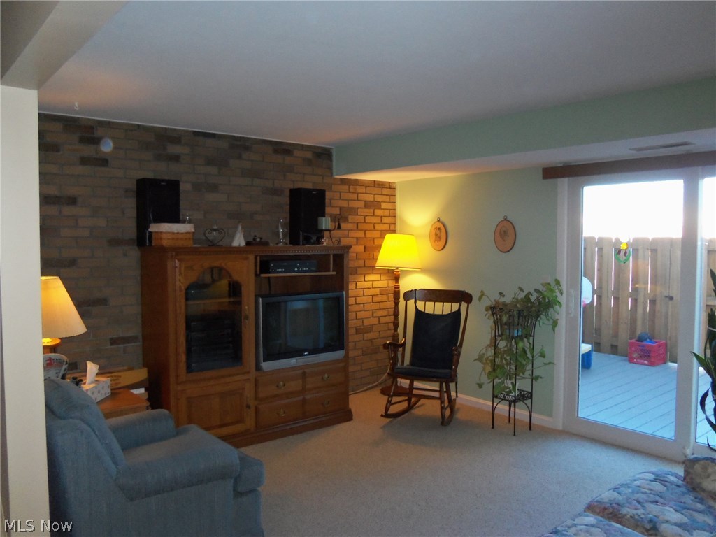 8749 West Ridge Road, Unit 7C Elyria, OH 44035 - Photo 10 of 28 Living Room with sliding glass door that leads to wood deck.