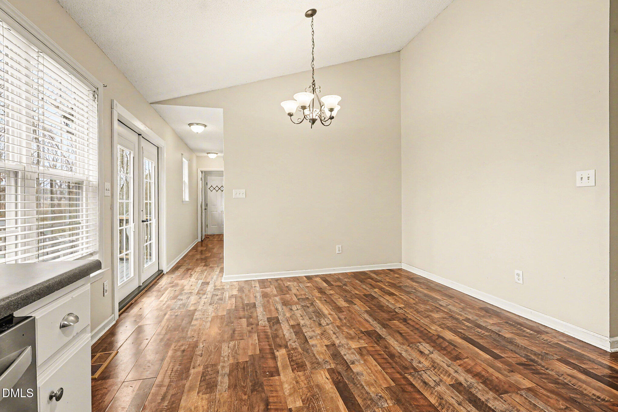 186 Turtle Point Drive Fuquay-Varina, NC 27526 - Photo 11 of 33 a view of a room with wooden floor chandelier and windows