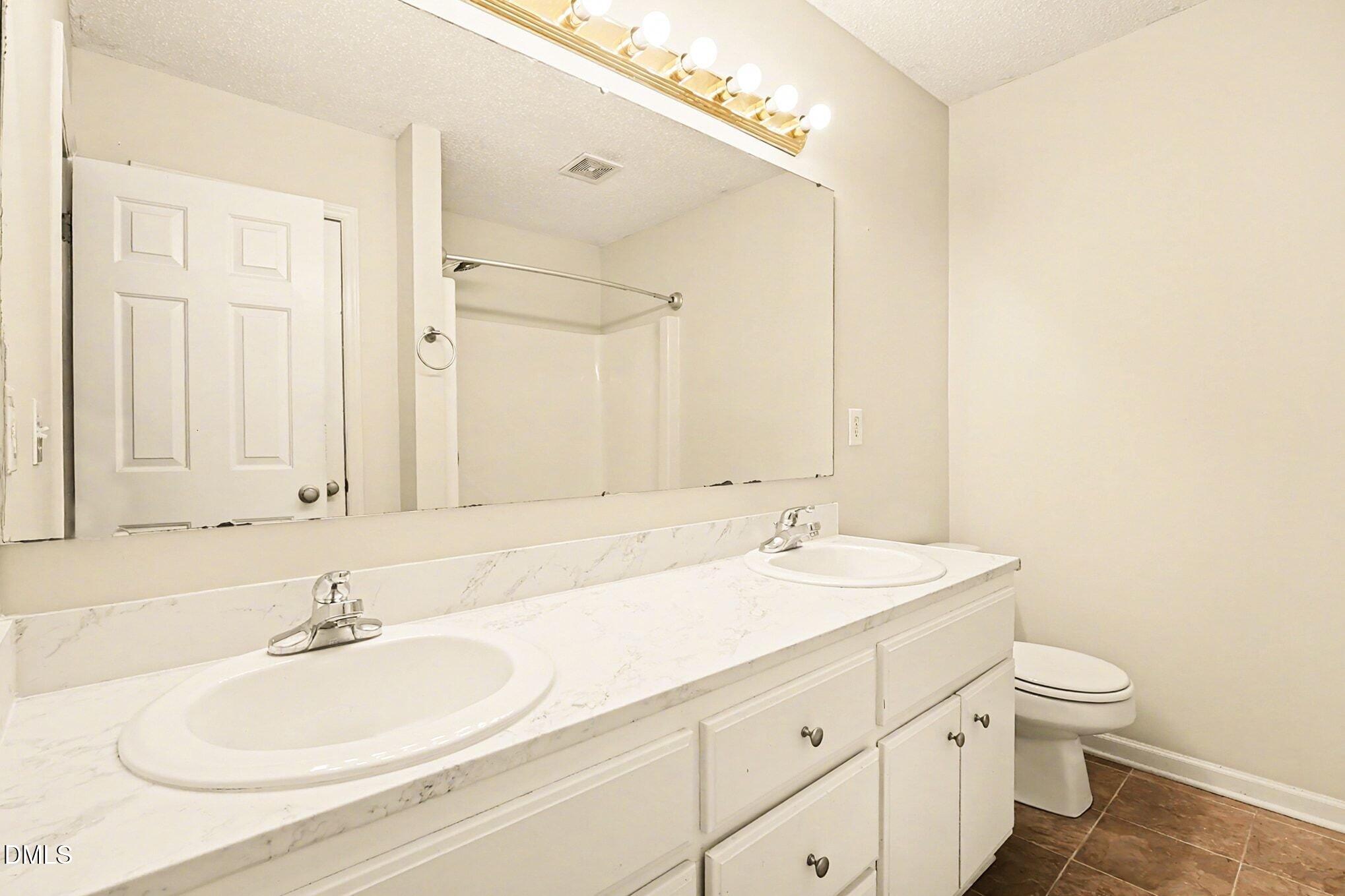 186 Turtle Point Drive Fuquay-Varina, NC 27526 - Photo 17 of 33 a bathroom with a sink and a mirror