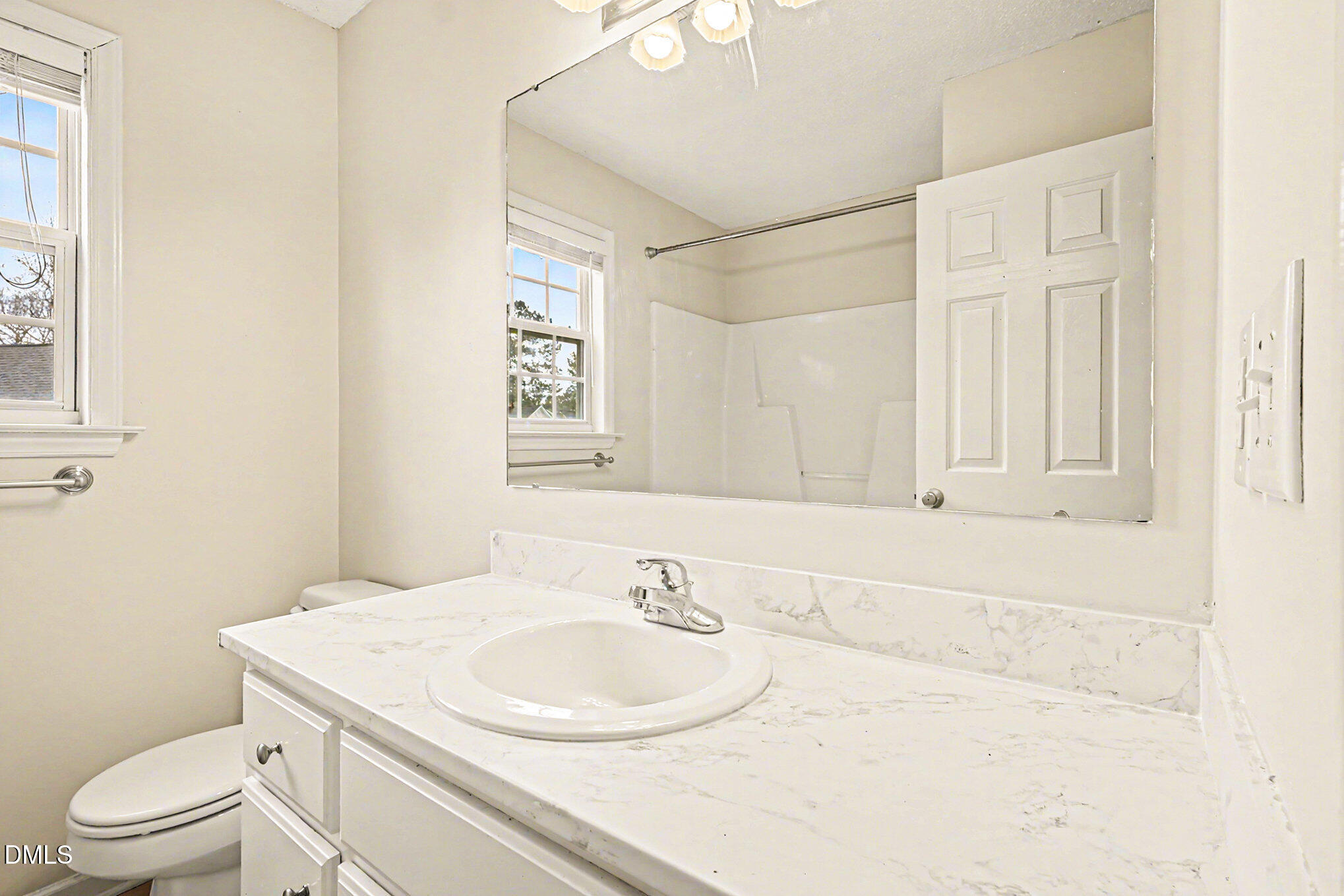186 Turtle Point Drive Fuquay-Varina, NC 27526 - Photo 22 of 33 a bathroom with a sink a toilet and a mirror