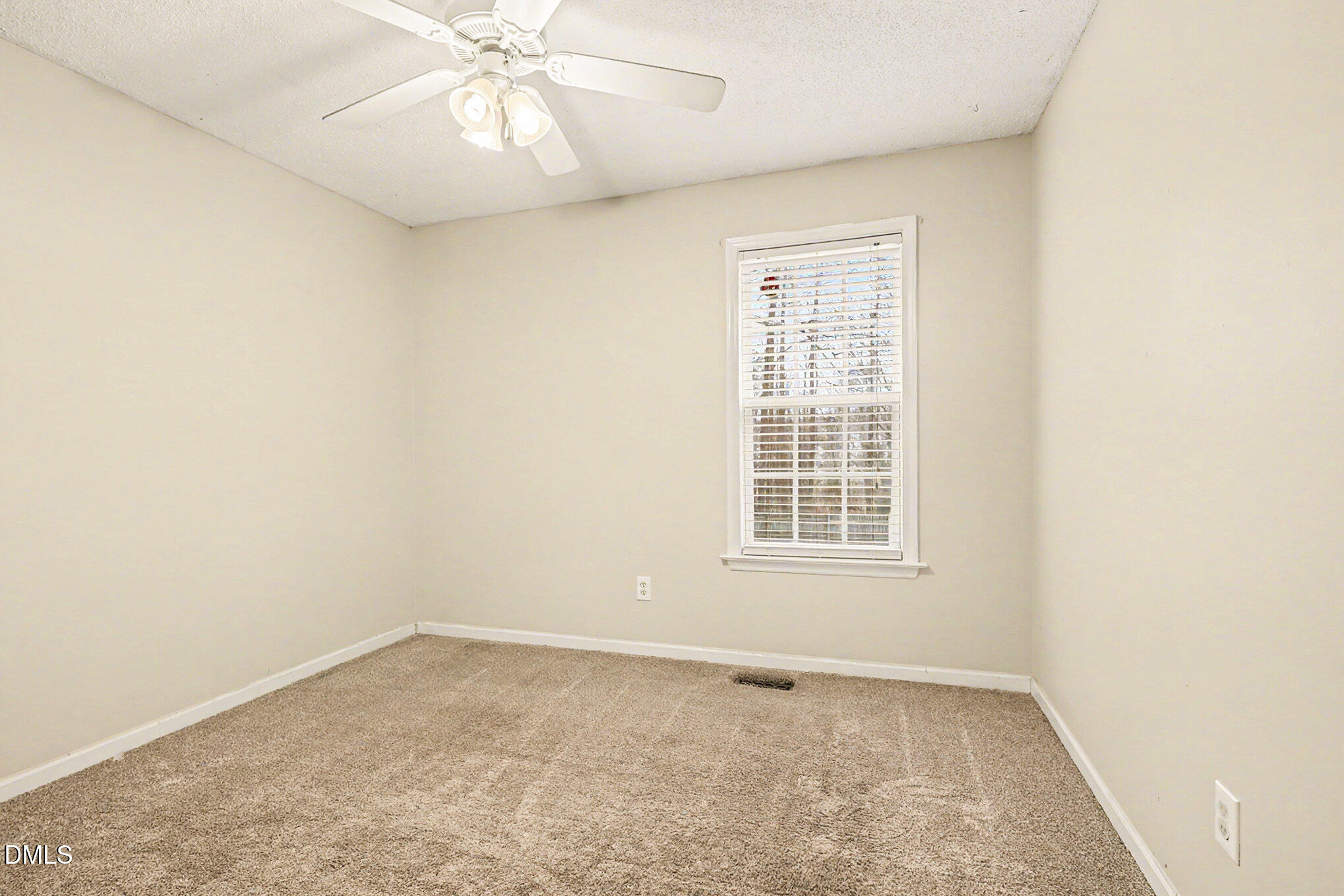 186 Turtle Point Drive Fuquay-Varina, NC 27526 - Photo 24 of 33 an empty room with a window and a ceiling fan