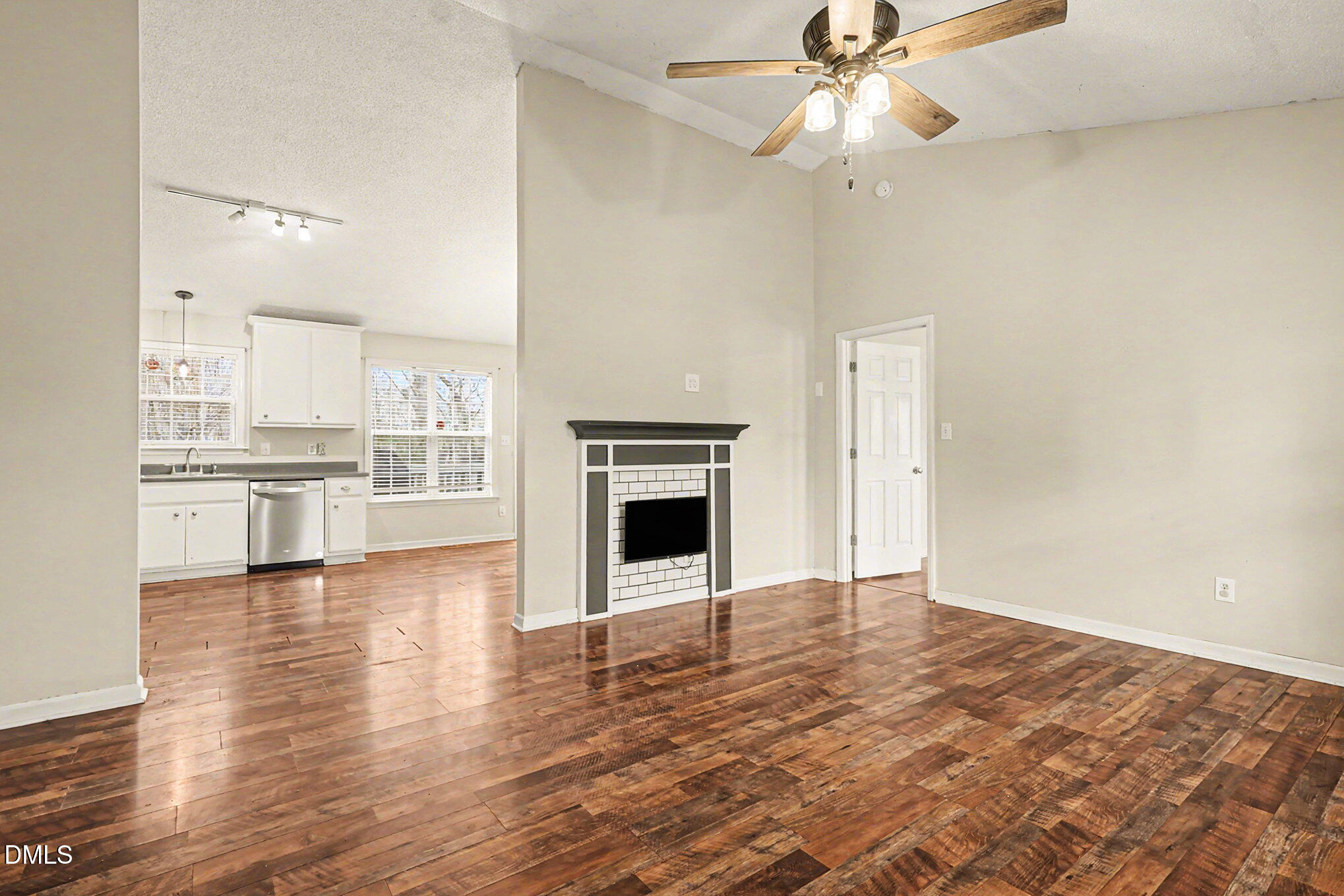 186 Turtle Point Drive Fuquay-Varina, NC 27526 - Photo 5 of 33 a view of a kitchen with wooden floor and a ceiling fan
