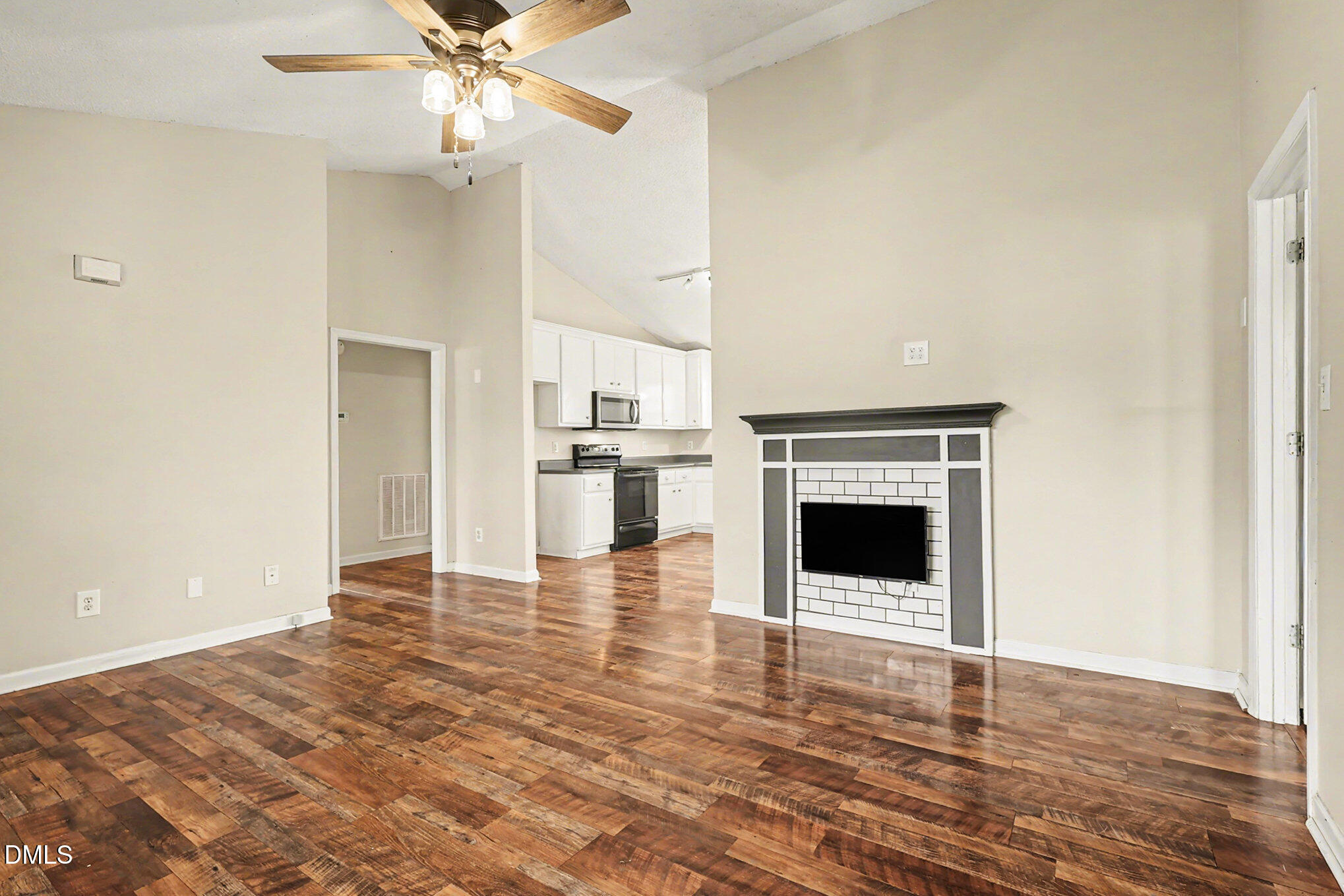 186 Turtle Point Drive Fuquay-Varina, NC 27526 - Photo 6 of 33 a view of a livingroom with a fireplace a ceiling fan and wooden floor