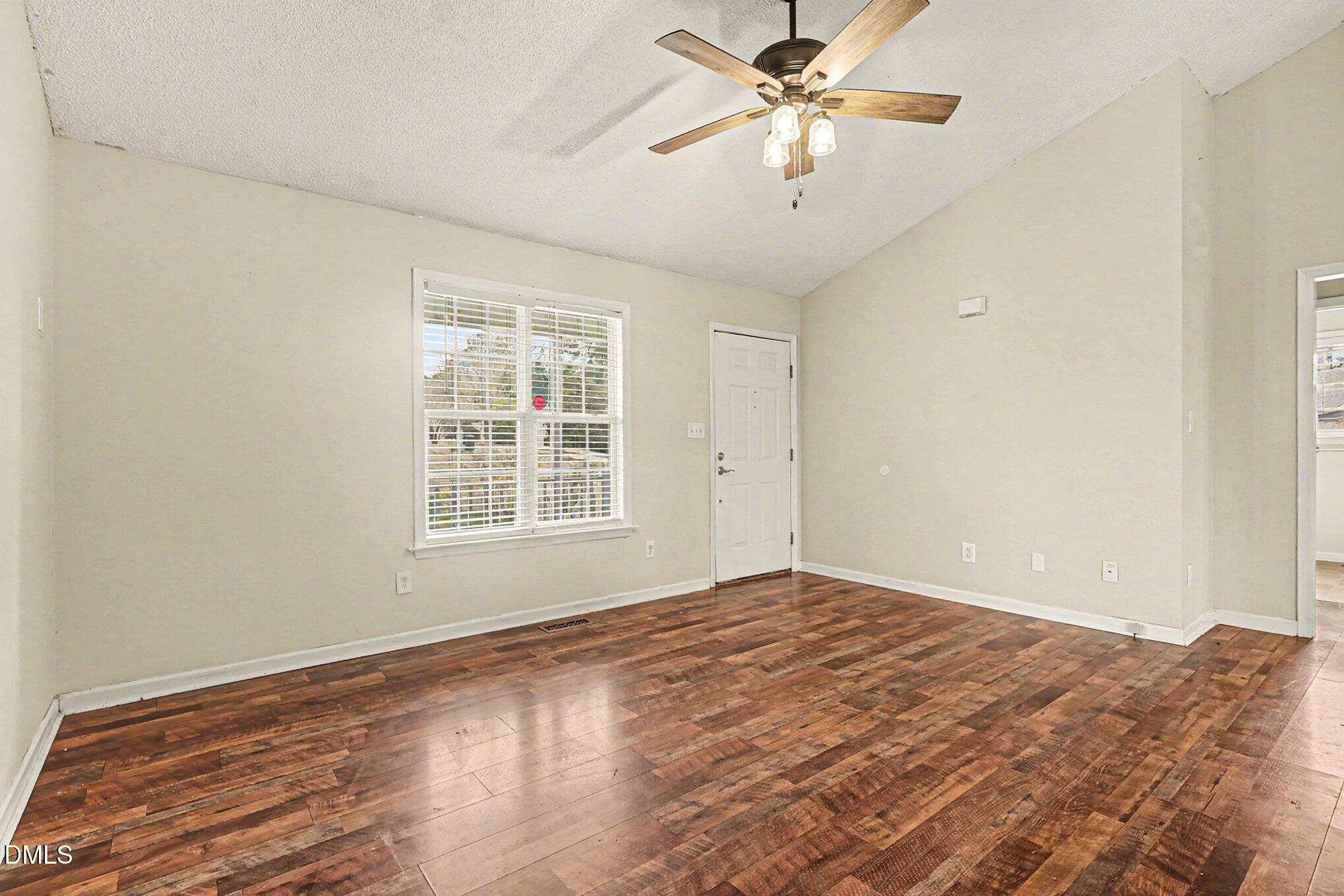 186 Turtle Point Drive Fuquay-Varina, NC 27526 - Photo 7 of 33 a view of a big room with wooden floor and a chandelier fan