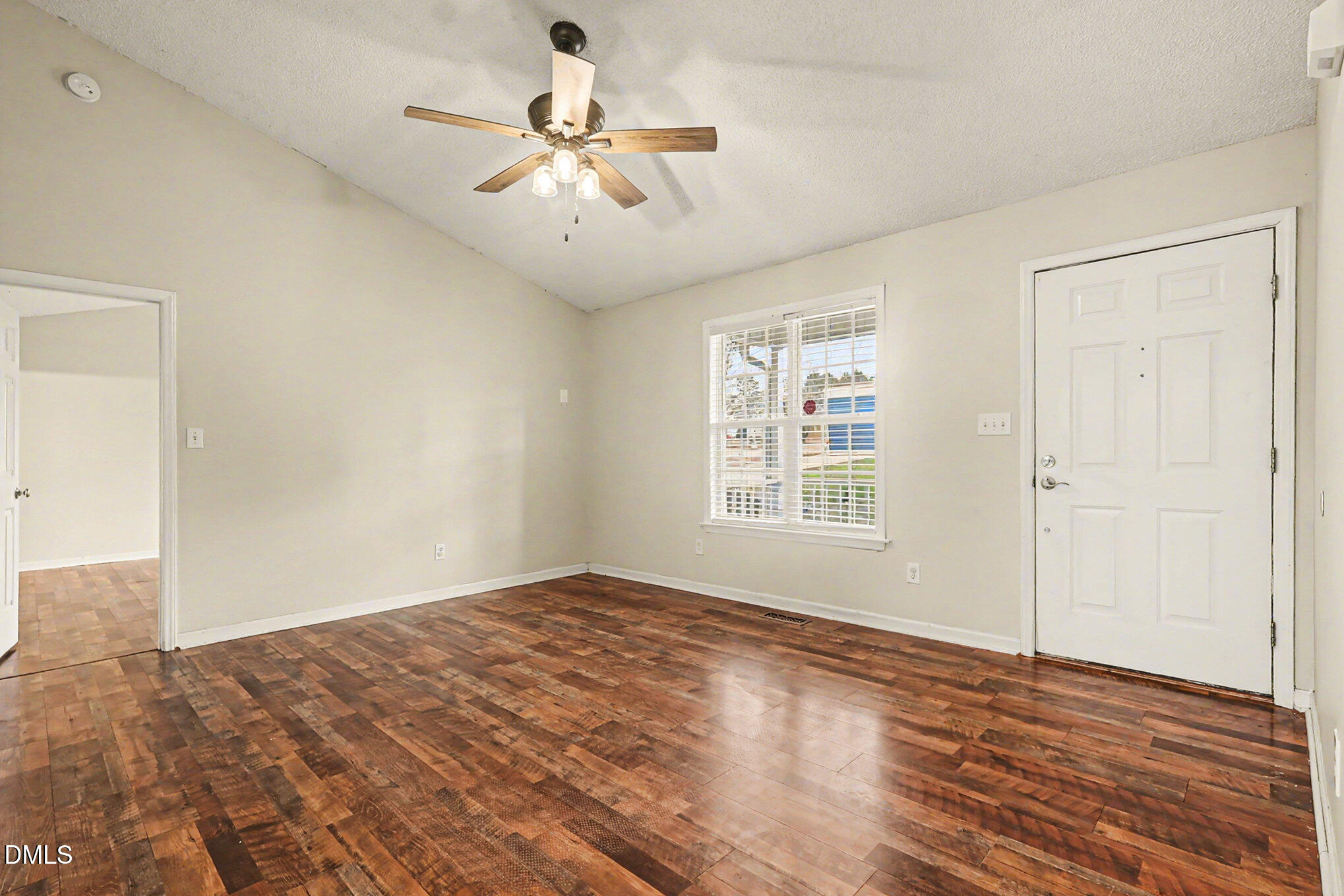 186 Turtle Point Drive Fuquay-Varina, NC 27526 - Photo 8 of 33 a view of an empty room with wooden floor and a window