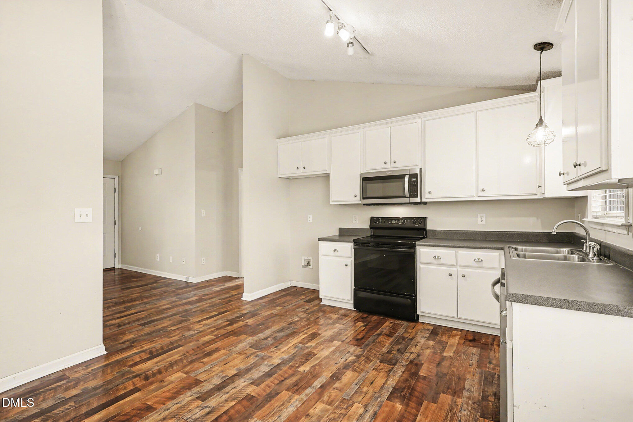 186 Turtle Point Drive Fuquay-Varina, NC 27526 - Photo 10 of 33 a kitchen with granite countertop a refrigerator stove top oven and sink