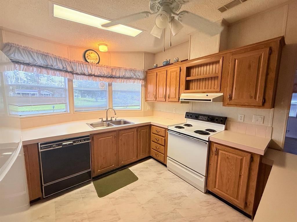 220 Ellsworth Drive Kissimmee, FL 34758 - Photo 11 of 40 a kitchen with stainless steel appliances granite countertop a sink and a stove