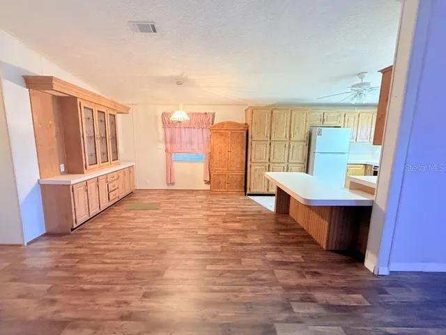 a large room with wooden floor and a window