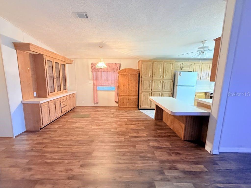 220 Ellsworth Drive Kissimmee, FL 34758 - Photo 13 of 40 a large room with wooden floor and a window