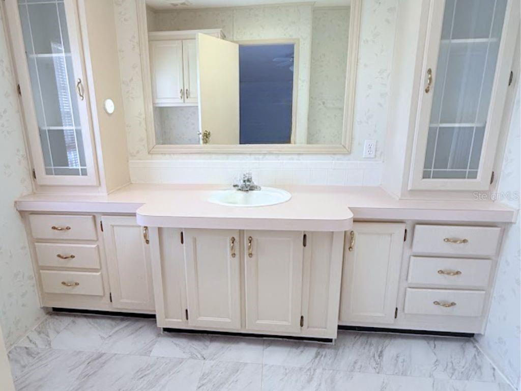 220 Ellsworth Drive Kissimmee, FL 34758 - Photo 21 of 40 a bathroom with a sink vanity and mirror