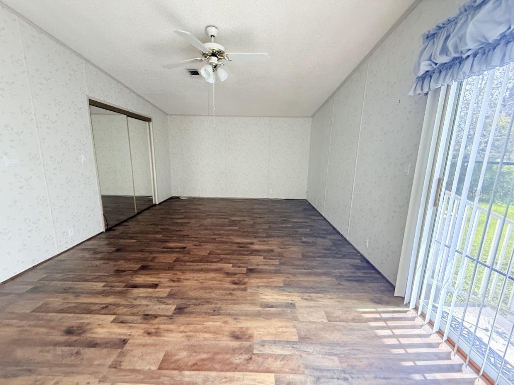 220 Ellsworth Drive Kissimmee, FL 34758 - Photo 24 of 40 wooden floor in an empty room with a window