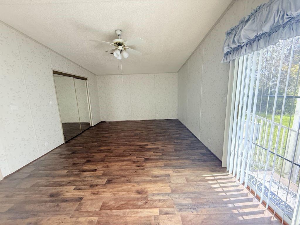 220 Ellsworth Drive Kissimmee, FL 34758 - Photo 26 of 40 wooden floor in an empty room with a window