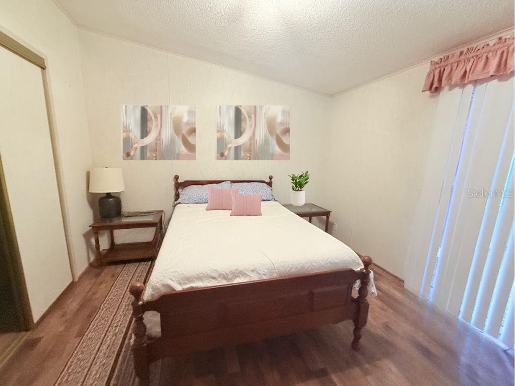 220 Ellsworth Drive Kissimmee, FL 34758 - Photo 28 of 40 a bedroom with a bed and a table in it