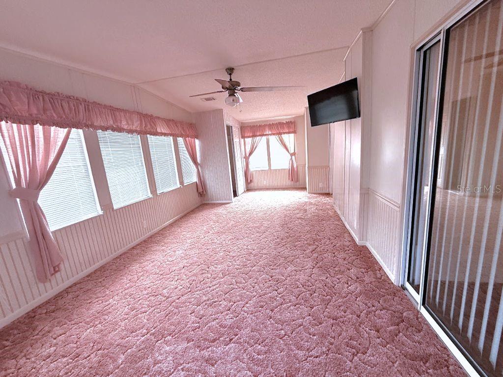 220 Ellsworth Drive Kissimmee, FL 34758 - Photo 29 of 40 wooden floor in an empty room with a window