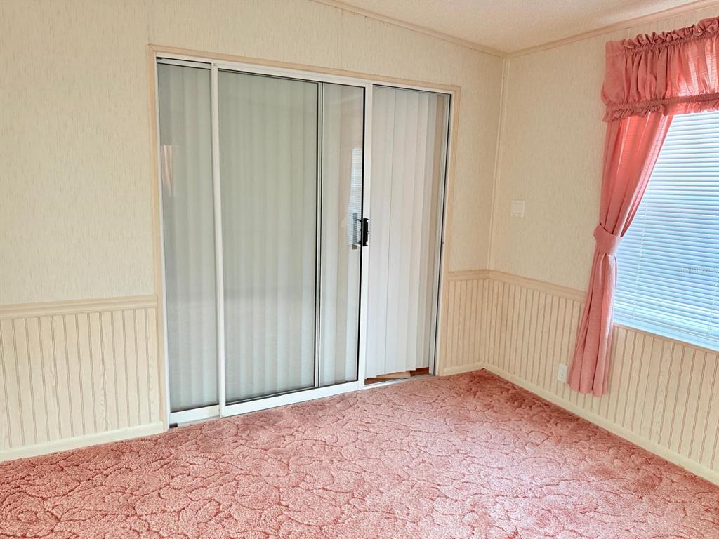 220 Ellsworth Drive Kissimmee, FL 34758 - Photo 30 of 40 a view of an empty room with wooden floor