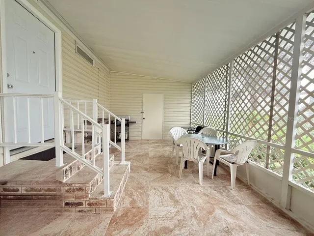 a living room with a large window and furniture