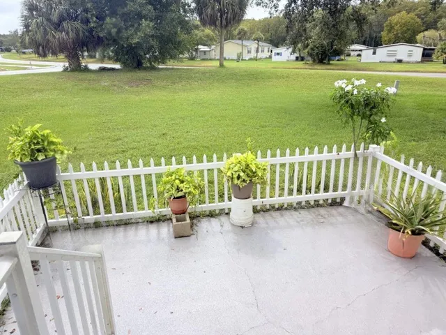 a view of an outdoor space with seating area and trees around