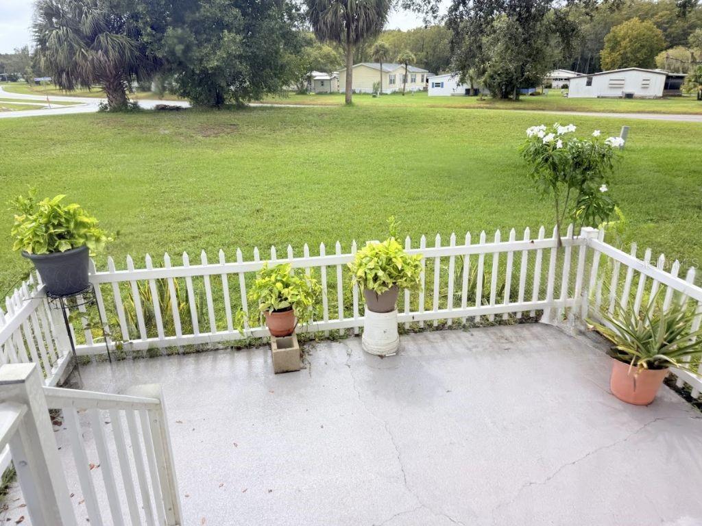 220 Ellsworth Drive Kissimmee, FL 34758 - Photo 4 of 40 a view of an outdoor space with seating area and trees around